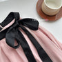 Elegant Pink Halter Neck Midi Dress with Black Bow Accent - Masion Chérie