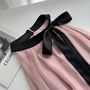 Elegant Pink Halter Neck Midi Dress with Black Bow Accent - Masion Chérie